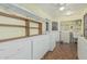 Efficient laundry room with ample cabinet storage, shelving, and appliances at 6051 E Ensenada St, Mesa, AZ 85205