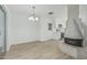 Bright living room with modern floors and a cozy brick fireplace, open to kitchen at 6051 E Ensenada St, Mesa, AZ 85205