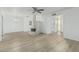 Spacious living room with a unique brick fireplace and new floors at 6051 E Ensenada St, Mesa, AZ 85205