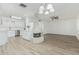 Open living space with modern flooring, a fireplace, and seamless transition to the updated kitchen at 6051 E Ensenada St, Mesa, AZ 85205