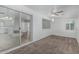 Bright sunroom features a brick fireplace, ceiling fan, sliding door to the backyard and carpet at 6051 E Ensenada St, Mesa, AZ 85205