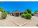 Backyard showcasing gravel ground cover and mature landscaping adjacent to a covered patio at 6180 W Oraibi Dr, Glendale, AZ 85308