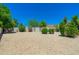Low-maintenance gravel backyard with mature landscaping and privacy hedges at 6180 W Oraibi Dr, Glendale, AZ 85308