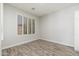 Bright bedroom with wood-style floors and plantation shutters at 6180 W Oraibi Dr, Glendale, AZ 85308