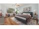 Charming bedroom with wood floors, a ceiling fan, and sitting area with bright natural light at 6180 W Oraibi Dr, Glendale, AZ 85308