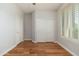 Spacious bedroom with wood floors, closet, and natural light from the window at 6180 W Oraibi Dr, Glendale, AZ 85308
