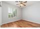 Well-lit bedroom with wood floors, ceiling fan, and shuttered window at 6180 W Oraibi Dr, Glendale, AZ 85308