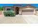 Charming single-story home with a well-maintained front yard and a two-car garage at 6180 W Oraibi Dr, Glendale, AZ 85308