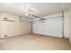Spacious two-car garage with built-in storage cabinets along the left wall at 6180 W Oraibi Dr, Glendale, AZ 85308