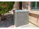 Air conditioning unit, located by the side of the home, near mature landscaping at 6180 W Oraibi Dr, Glendale, AZ 85308