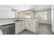Open kitchen design with stainless steel dishwasher, sink, and view to the living room at 6180 W Oraibi Dr, Glendale, AZ 85308