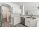Bright kitchen with stainless steel appliances, white cabinets, and a dual basin sink at 6180 W Oraibi Dr, Glendale, AZ 85308