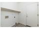 A basic laundry room with a shelf and hookups for washer and dryer at 6180 W Oraibi Dr, Glendale, AZ 85308