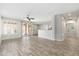 Open-concept living room featuring wood-style floors and plenty of natural light at 6180 W Oraibi Dr, Glendale, AZ 85308
