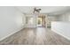 Spacious living room with wood-style floors and sliding door to patio at 6180 W Oraibi Dr, Glendale, AZ 85308