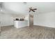Open living space featuring a kitchen with white cabinets and dining space at 6180 W Oraibi Dr, Glendale, AZ 85308