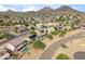 An aerial view of community showcasing neighborhood houses with solar panels and pools at 6827 W El Cortez Pl, Peoria, AZ 85383