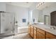 Bright primary bathroom featuring dual sinks, soaking tub, and glass enclosed shower at 6827 W El Cortez Pl, Peoria, AZ 85383