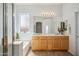 Bright primary bathroom featuring dual sinks, soaking tub, and glass enclosed shower at 6827 W El Cortez Pl, Peoria, AZ 85383