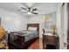 A quaint bedroom displays wood floors, a ceiling fan, and a wooden headboard bed frame at 6827 W El Cortez Pl, Peoria, AZ 85383