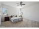Bright bedroom with neutral carpet, shutters, and ceiling fan at 6827 W El Cortez Pl, Peoria, AZ 85383