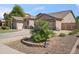 Charming single-story home showcasing desert landscaping, a two-car garage, and a well-kept front yard at 6827 W El Cortez Pl, Peoria, AZ 85383