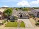 Well-maintained single-story home featuring green lawn, desert landscaping, and attached two-car garage at 6827 W El Cortez Pl, Peoria, AZ 85383