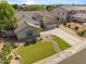 Beautiful single-story home with a well-manicured lawn, mature trees, and a brick-paved walkway at 6827 W El Cortez Pl, Peoria, AZ 85383