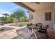 Covered patio features an outdoor table and chairs, overlooking a well-maintained backyard at 6827 W El Cortez Pl, Peoria, AZ 85383