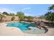 Sparkling pool featuring a rock waterfall, charming turtle design and inviting lounge area at 6827 W El Cortez Pl, Peoria, AZ 85383
