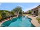 Beautiful backyard pool with rock waterfall feature and mature landscaping, perfect for outdoor entertaining at 6827 W El Cortez Pl, Peoria, AZ 85383