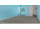Comfortable carpeted bedroom with natural light, closet space, ideal for relaxation, and is painted in a bright blue tone at 747 S Extension Rd # 113, Mesa, AZ 85210