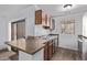 The kitchen features wood cabinets and a breakfast bar perfect for casual dining and flows into the living space at 747 S Extension Rd # 113, Mesa, AZ 85210