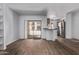 Bright living room features sliding glass doors offering outdoor views and flows into the kitchen area with stainless steel appliances at 747 S Extension Rd # 113, Mesa, AZ 85210