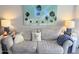 Living room view of a gray couch with decorative pillows and artwork of palm trees above at 7625 E Camelback Rd # B241, Scottsdale, AZ 85251