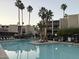 Inviting community pool with palm trees and resort-style loungers at 7625 E Camelback Rd # B241, Scottsdale, AZ 85251