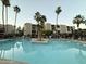 Relaxing community pool area with palm trees and lounge chairs at 7625 E Camelback Rd # B241, Scottsdale, AZ 85251