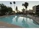 Serene community pool area with palm trees reflecting in the water at 7625 E Camelback Rd # B241, Scottsdale, AZ 85251