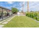 Large backyard with artificial turf, a fire pit, and covered patio at 7802 E Hubbell St, Scottsdale, AZ 85257