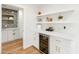 Stylish bar area with shelving, wine cooler, and ample counter space at 7802 E Hubbell St, Scottsdale, AZ 85257