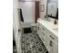 Modern bathroom features a double sink vanity, decorative tile floor, and updated shower at 7802 E Hubbell St, Scottsdale, AZ 85257