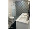 Modern bathroom featuring a double sink vanity, patterned tile and glass shower at 7802 E Hubbell St, Scottsdale, AZ 85257