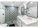 Elegant bathroom with a double sink vanity, stylish mirrors, and a beautifully tiled shower at 7802 E Hubbell St, Scottsdale, AZ 85257
