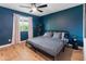 Bedroom with hardwood floors, dark blue accent wall, and light colored window coverings at 7802 E Hubbell St, Scottsdale, AZ 85257