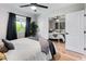 Bright bedroom with wood floors, ceiling fan, and sliding closet doors reflects another bedroom at 7802 E Hubbell St, Scottsdale, AZ 85257