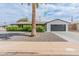 Charming single-story home with attached garage, tidy landscaping, and a mature palm tree at 7802 E Hubbell St, Scottsdale, AZ 85257