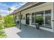 Inviting covered front porch with black door and white brickwork, complemented by lush greenery at 7802 E Hubbell St, Scottsdale, AZ 85257