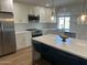 Modern kitchen with stainless steel appliances, white cabinets, and a large island at 7802 E Hubbell St, Scottsdale, AZ 85257