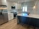 Modern kitchen with stainless steel appliances, white cabinets, and a large island at 7802 E Hubbell St, Scottsdale, AZ 85257