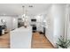Modern kitchen with an island, pendant lighting, stainless steel appliances, and white cabinetry at 7802 E Hubbell St, Scottsdale, AZ 85257